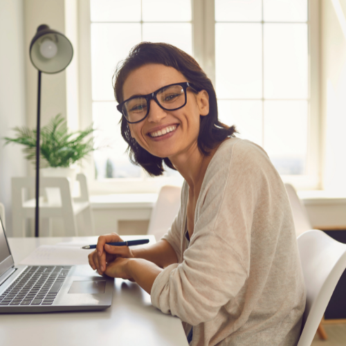 adult at a computer smiling